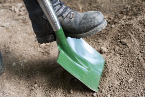 Man digging with a garden shovel